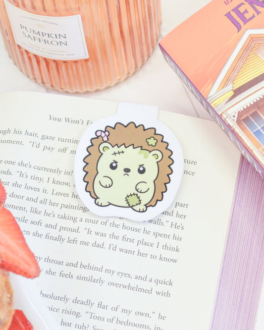 a bookmark with a cartoon hedgehog on top of a book