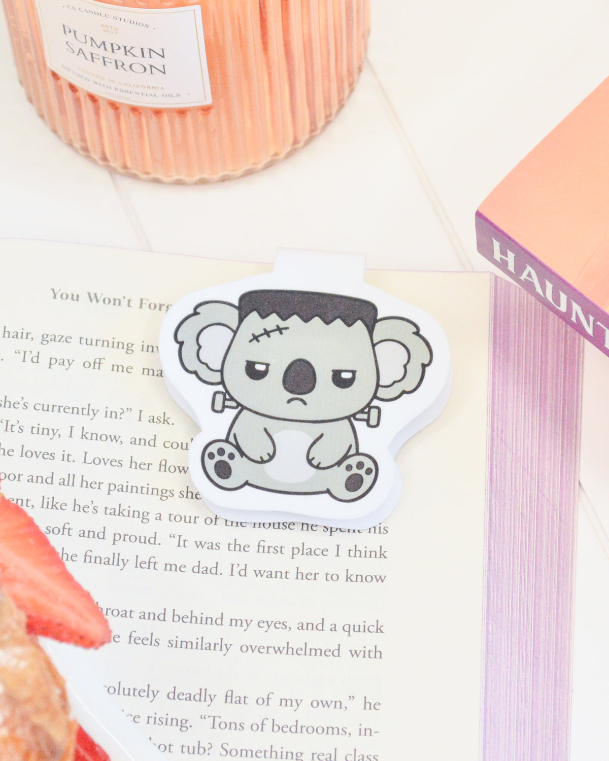 a paper with a cartoon koala on it next to a book