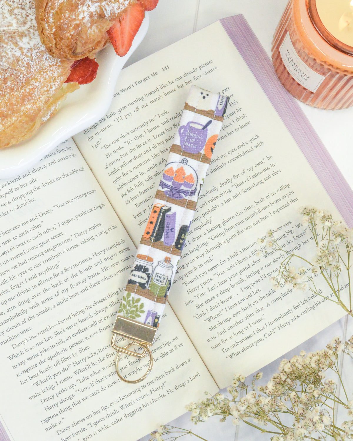 a book with a key chain and a plate of food