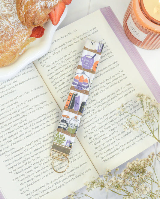 a book with a key chain and a plate of food