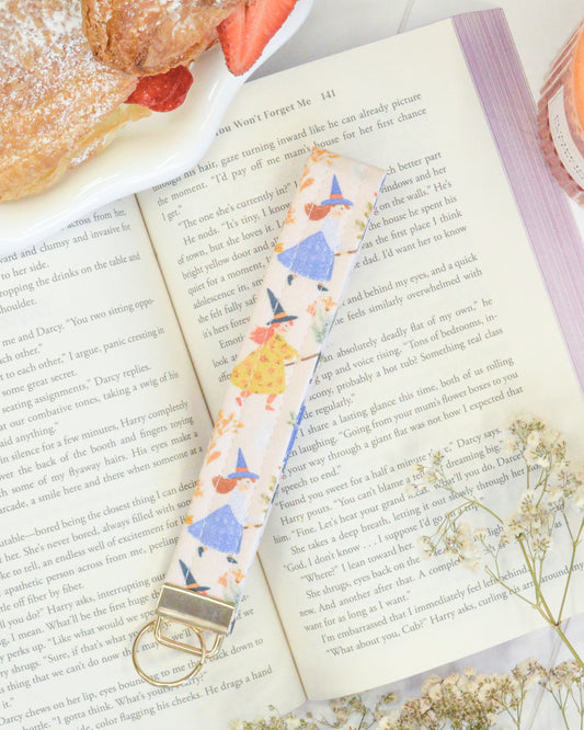 a book with a key chain and a plate of food