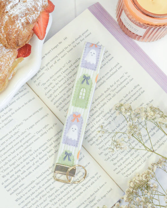 a book with a key chain and a plate of food