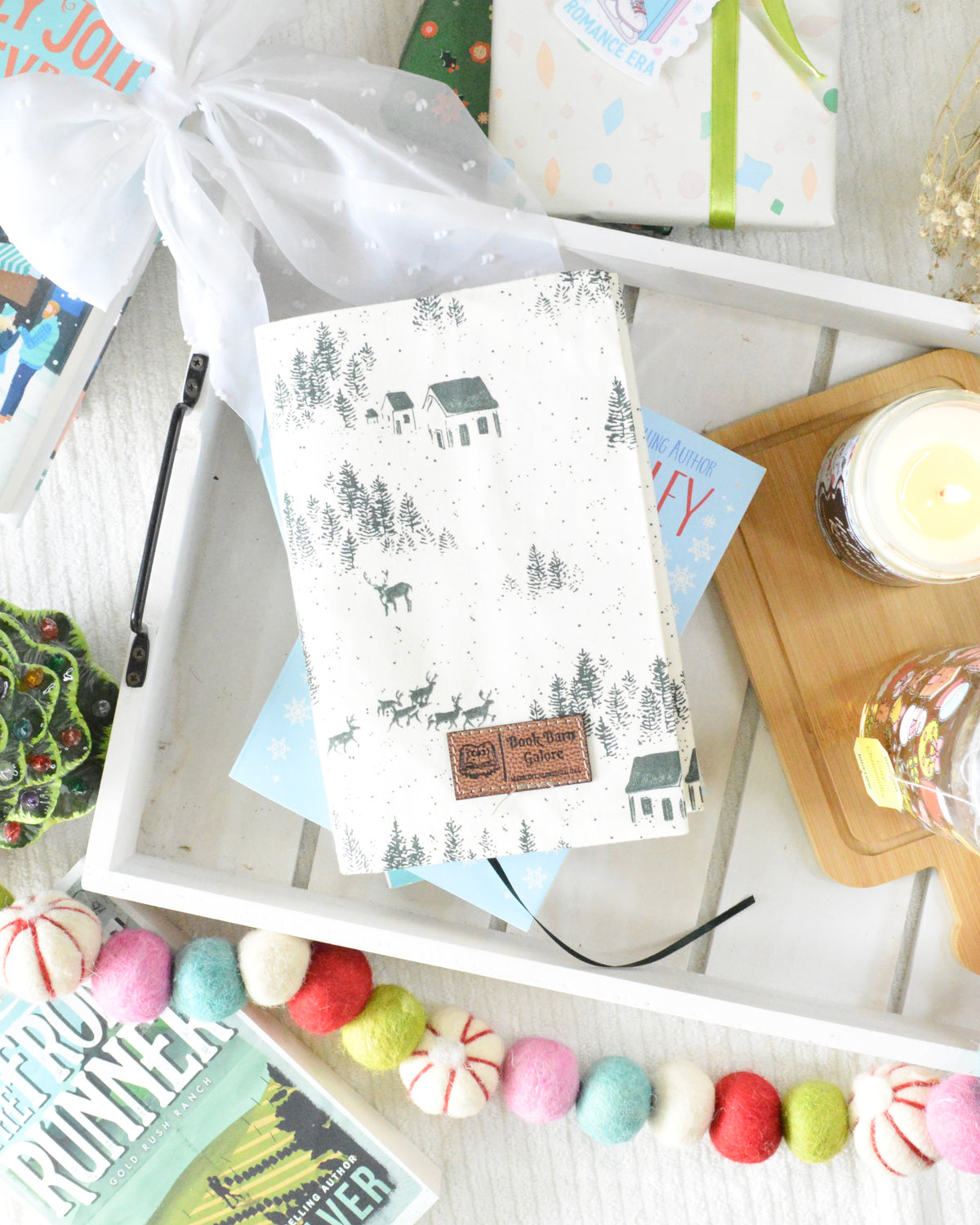 a white tray with a book and candles